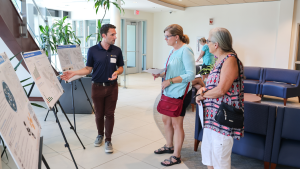 Three people standing and talking at an Integrated Mobility Plan Workshop