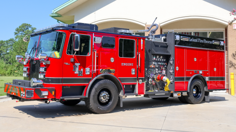 Red fire engine in front of the fire station