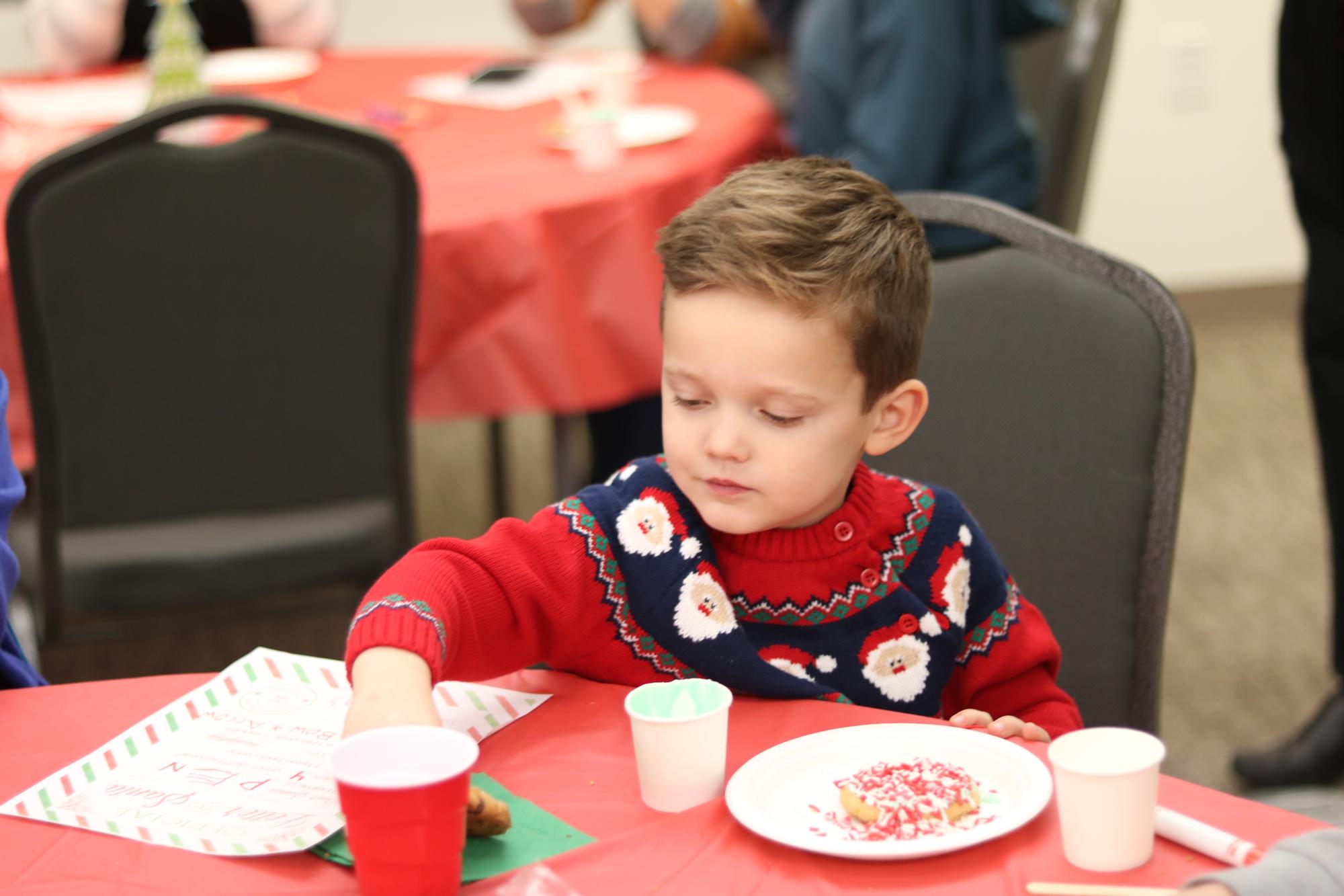 Child sitting at table with cookies