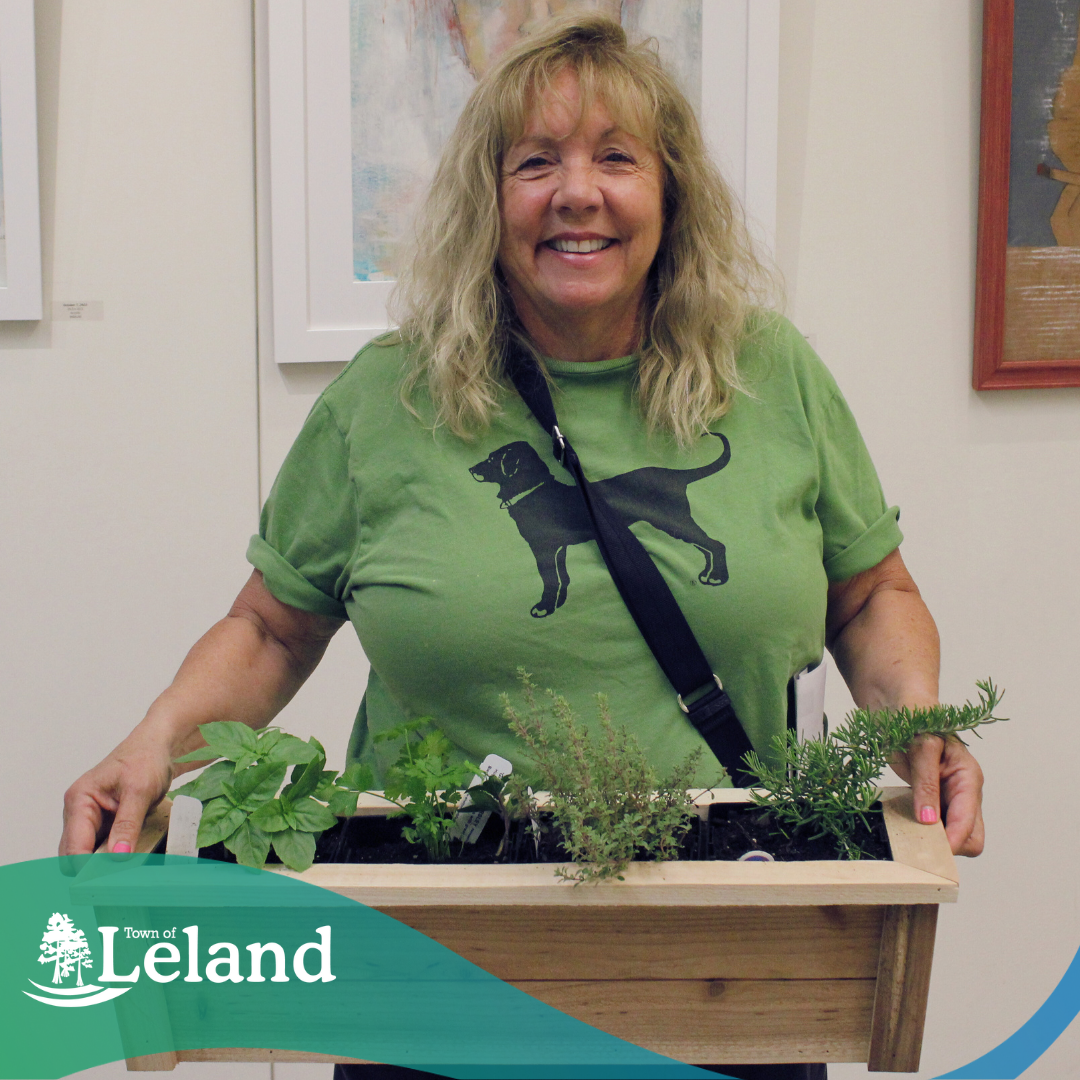 Woman holding cedar salad planter and smiling